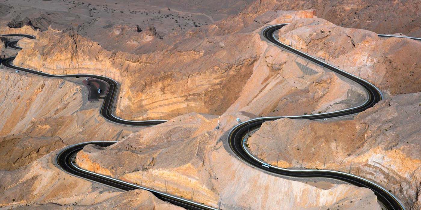 Jebel Hafit mountain road winding through dramatic rocky terrain, Al Ain